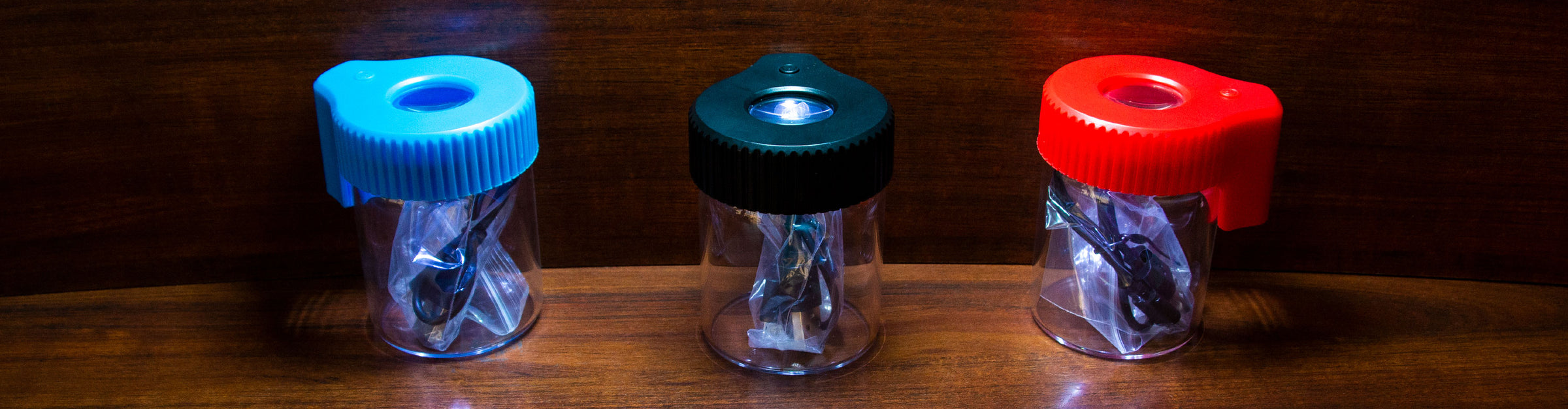 The Sticker Cartel MAGJARs lined in a row standing on wooden table inside office