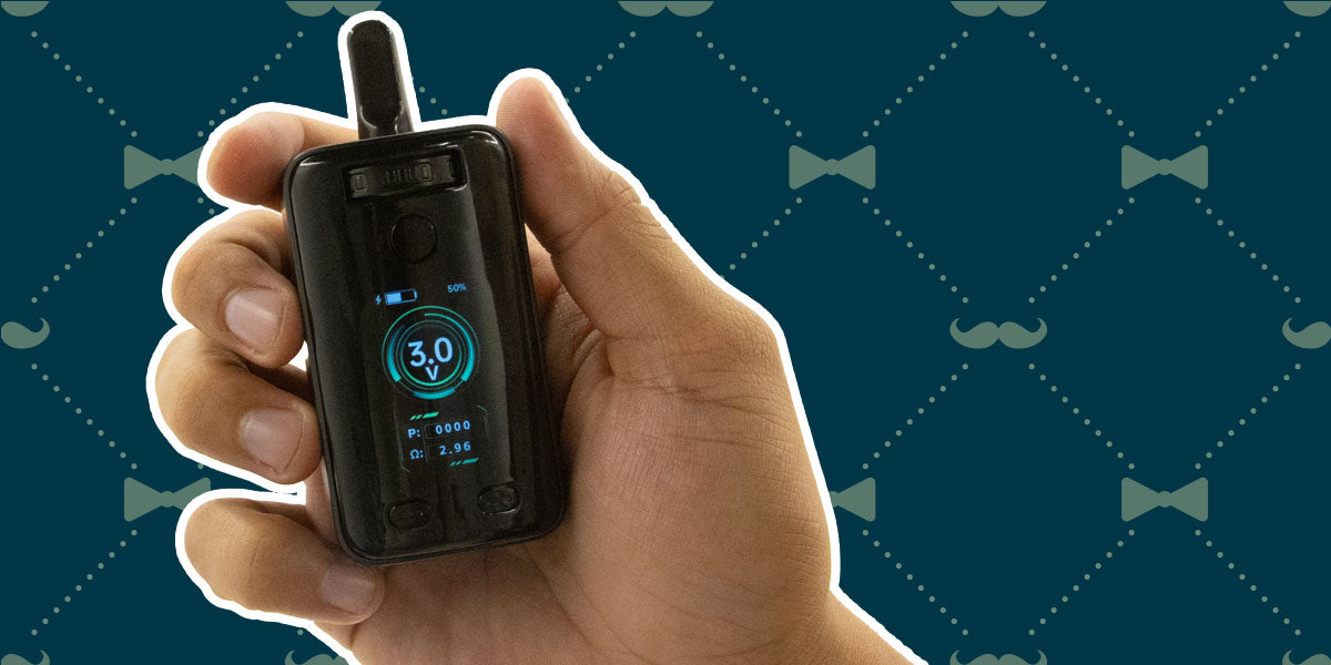 Hand holding a Wulf Uni 3.0 device with a digital display against a patterned background